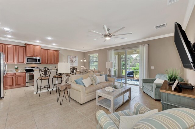 living room featuring light tile patterned flooring, crown molding, and ceiling fan