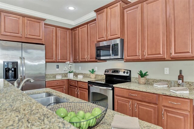 kitchen with appliances with stainless steel finishes, crown molding, and light stone counters