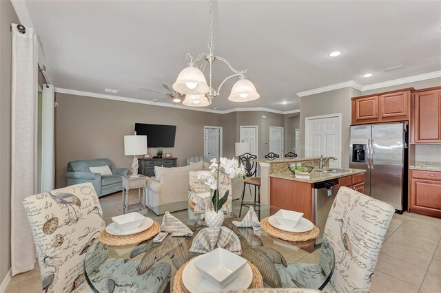 dining room featuring ornamental molding, sink, ceiling fan with notable chandelier, and light tile patterned floors