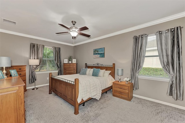 carpeted bedroom with ceiling fan and crown molding