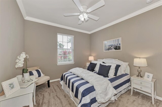 bedroom featuring ceiling fan, ornamental molding, and light colored carpet