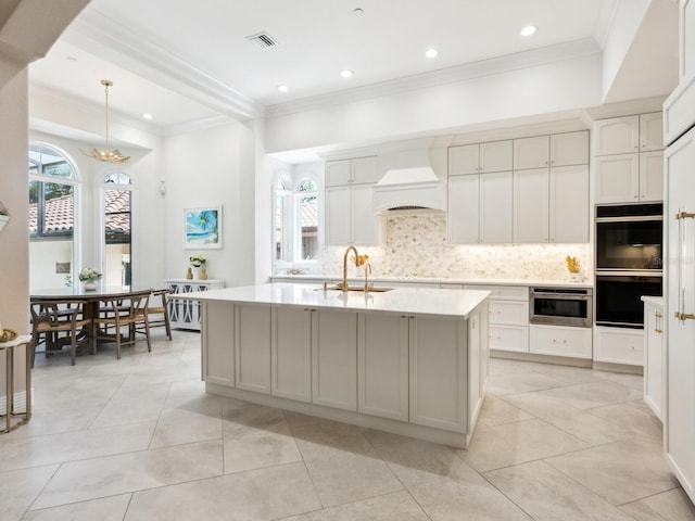 kitchen featuring double oven, a sink, light countertops, tasteful backsplash, and custom range hood