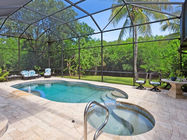 view of pool with a patio area and a lanai