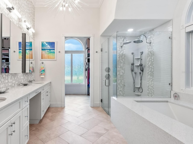 bathroom with backsplash, ornamental molding, dual vanity, shower with separate bathtub, and tile patterned floors