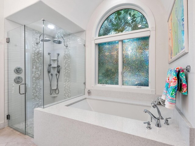 bathroom with separate shower and tub and tile patterned floors