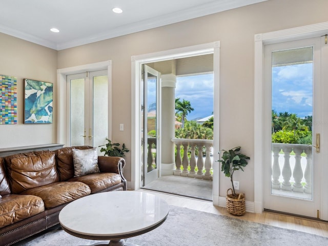 living area with recessed lighting, wood finished floors, baseboards, french doors, and ornamental molding