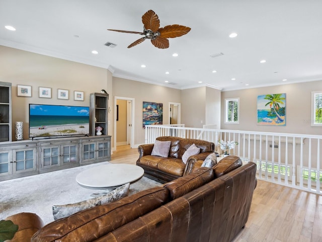 living room with light wood finished floors, plenty of natural light, and recessed lighting