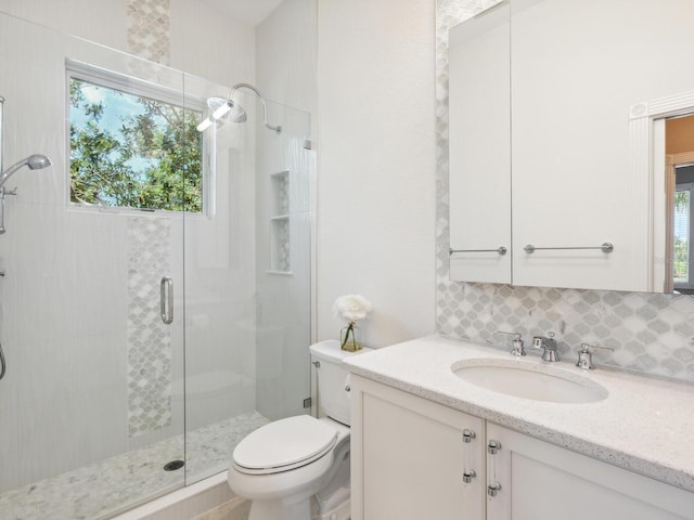 full bathroom featuring a stall shower, toilet, and a healthy amount of sunlight