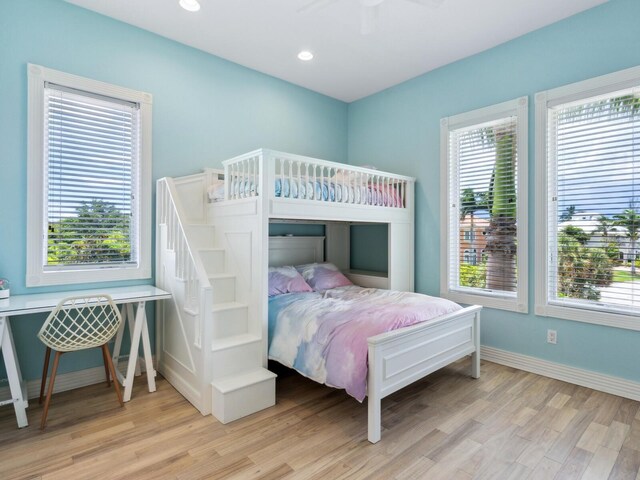 bedroom with ceiling fan and light hardwood / wood-style flooring