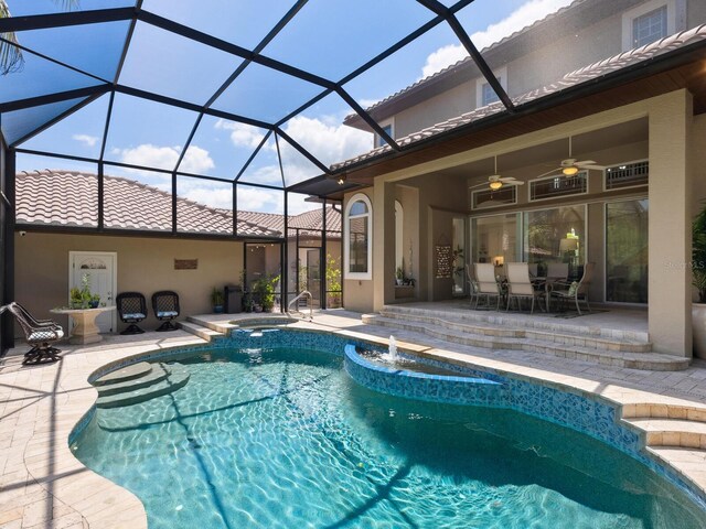 view of pool featuring ceiling fan, a lanai, an in ground hot tub, and a patio