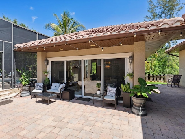 view of patio / terrace featuring glass enclosure and fence