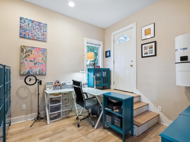 office area with baseboards and wood finished floors