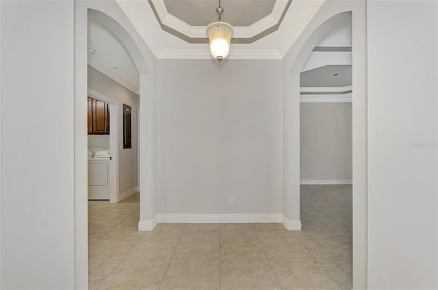 hallway with a raised ceiling, crown molding, and washer / clothes dryer