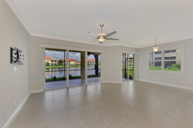 tiled empty room featuring ceiling fan, a healthy amount of sunlight, a water view, and crown molding