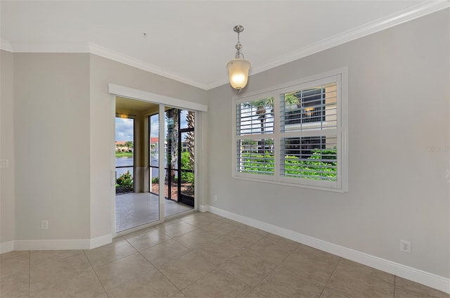 tiled spare room featuring a water view and ornamental molding