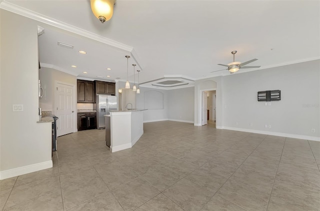 unfurnished living room with ceiling fan, sink, and crown molding