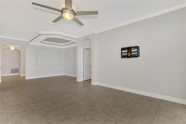 spare room with ceiling fan, tile patterned flooring, and ornamental molding