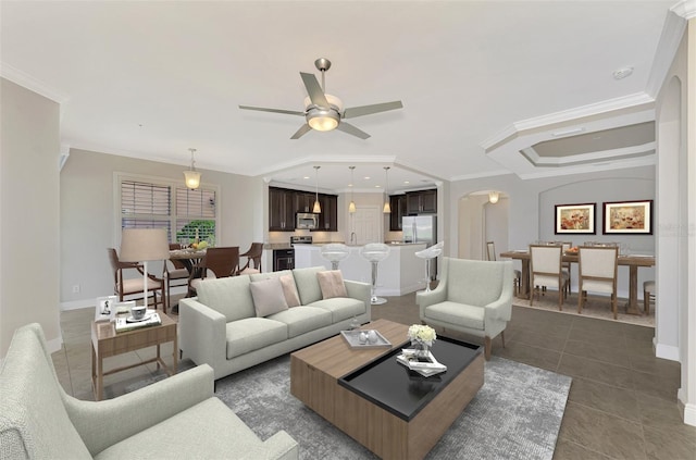 tiled living room featuring ceiling fan and ornamental molding