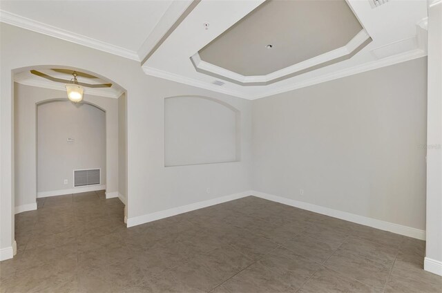 unfurnished room with a raised ceiling and crown molding