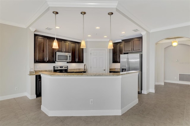 kitchen featuring dark brown cabinetry, light stone counters, decorative light fixtures, an island with sink, and stainless steel appliances