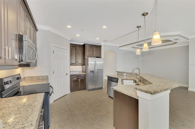 kitchen with sink, hanging light fixtures, light stone counters, dark brown cabinets, and appliances with stainless steel finishes