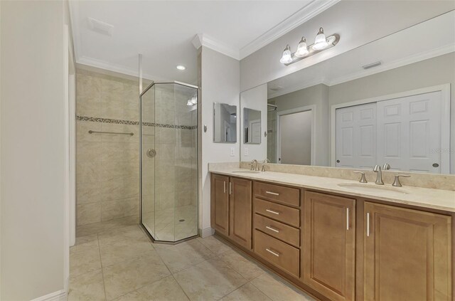 bathroom featuring tile patterned flooring, vanity, crown molding, and a shower with shower door