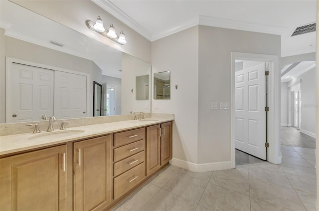 bathroom with tile patterned flooring, vanity, and crown molding