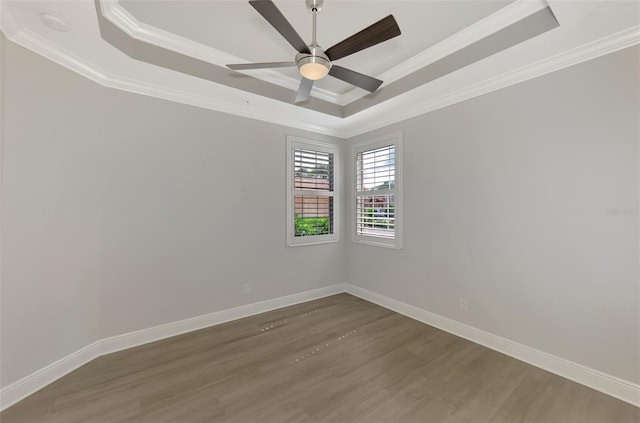 unfurnished room featuring ceiling fan, ornamental molding, a raised ceiling, and hardwood / wood-style floors