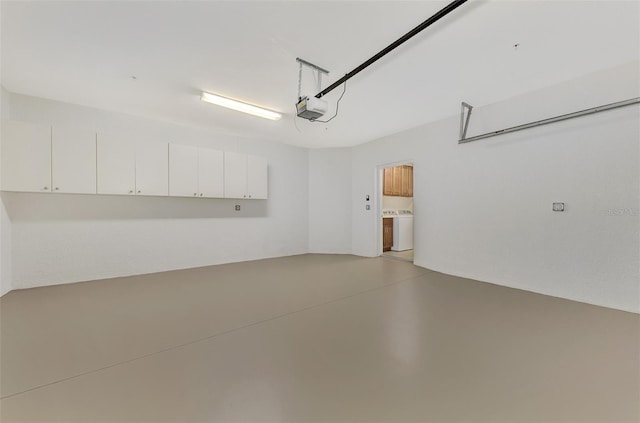 garage featuring a garage door opener and washer / clothes dryer