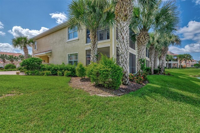 view of side of property with a lawn