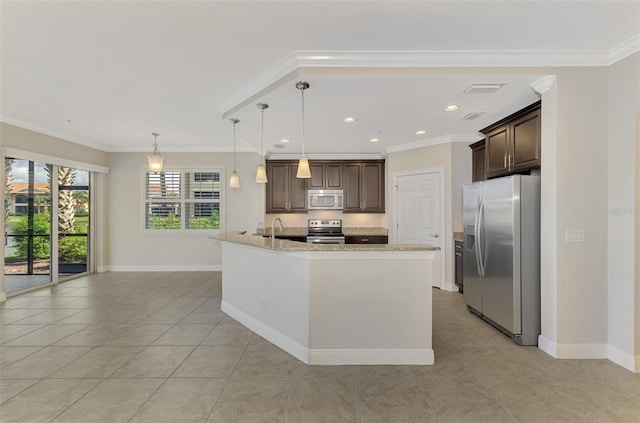 kitchen featuring sink, decorative light fixtures, dark brown cabinets, appliances with stainless steel finishes, and a kitchen island with sink