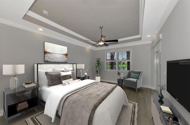 bedroom with dark hardwood / wood-style floors, a raised ceiling, ceiling fan, and crown molding