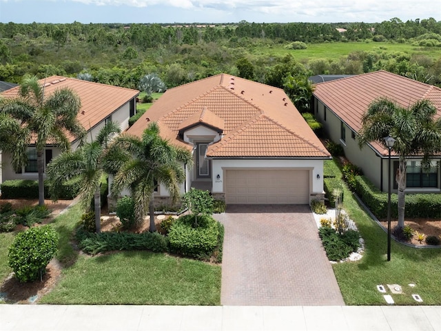 view of front of home with a garage and a front lawn