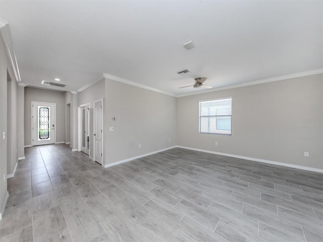 empty room featuring ceiling fan, plenty of natural light, and ornamental molding