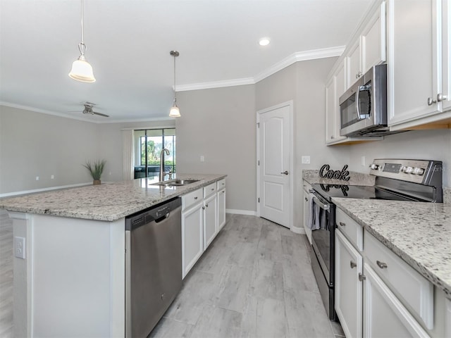 kitchen featuring sink, stainless steel appliances, white cabinets, and a center island with sink