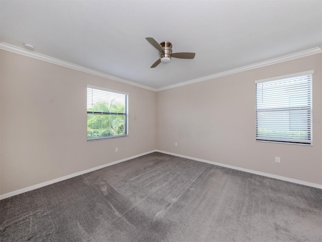 carpeted spare room featuring ornamental molding and ceiling fan