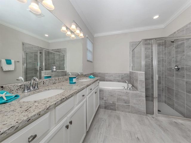 bathroom featuring crown molding, separate shower and tub, and vanity