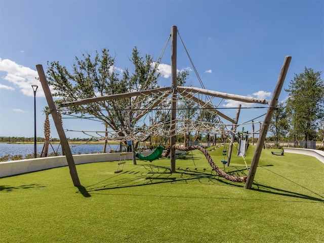 view of playground with a water view and a yard