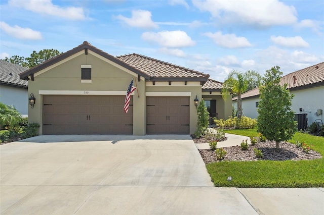 view of front of property featuring driveway, central AC, an attached garage, and stucco siding