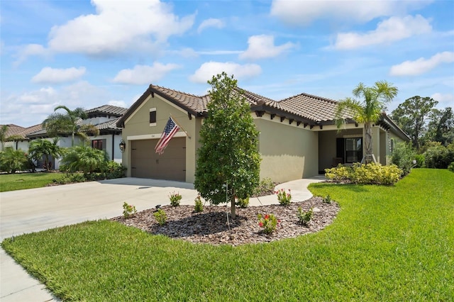 mediterranean / spanish house featuring a garage and a front yard