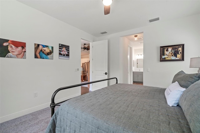 bedroom featuring ceiling fan, ensuite bathroom, and carpet