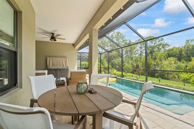 exterior space featuring ceiling fan, a patio, and glass enclosure