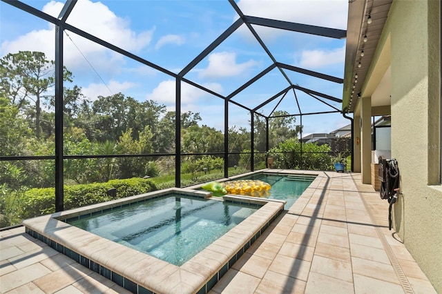 view of swimming pool with a lanai, a patio, and an in ground hot tub