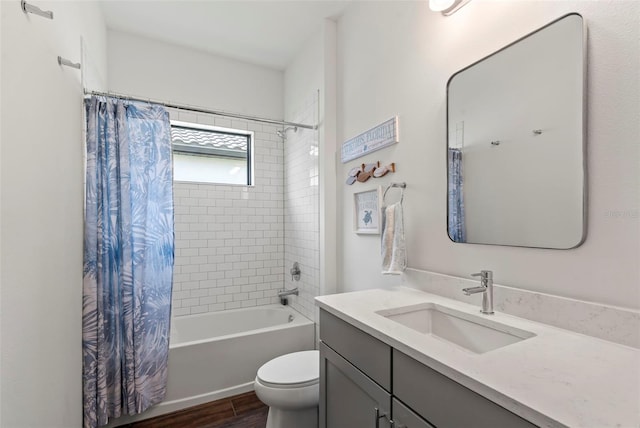 full bathroom with shower / bathtub combination with curtain, toilet, and vanity