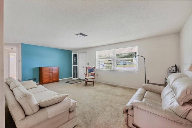 living room with light carpet and a textured ceiling