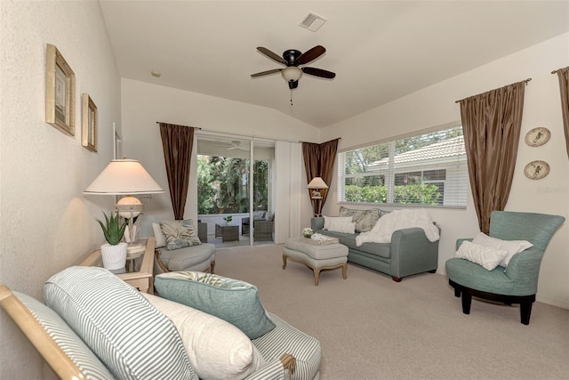 living room featuring carpet floors, ceiling fan, and vaulted ceiling