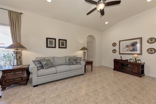 living room featuring ceiling fan, vaulted ceiling, and light tile patterned flooring