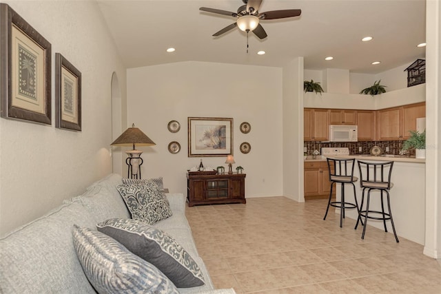 living room with ceiling fan, high vaulted ceiling, and light tile patterned floors