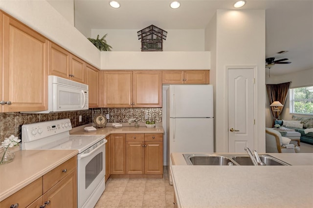 kitchen featuring tasteful backsplash, sink, light tile patterned floors, white appliances, and ceiling fan