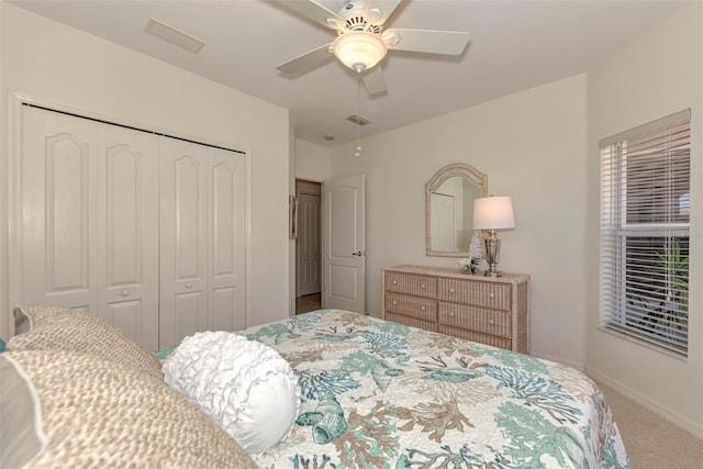 bedroom featuring ceiling fan, a closet, and carpet flooring